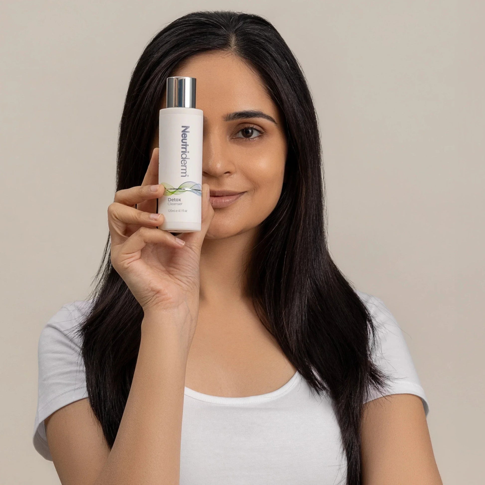 woman holding glycolic facial cleanser