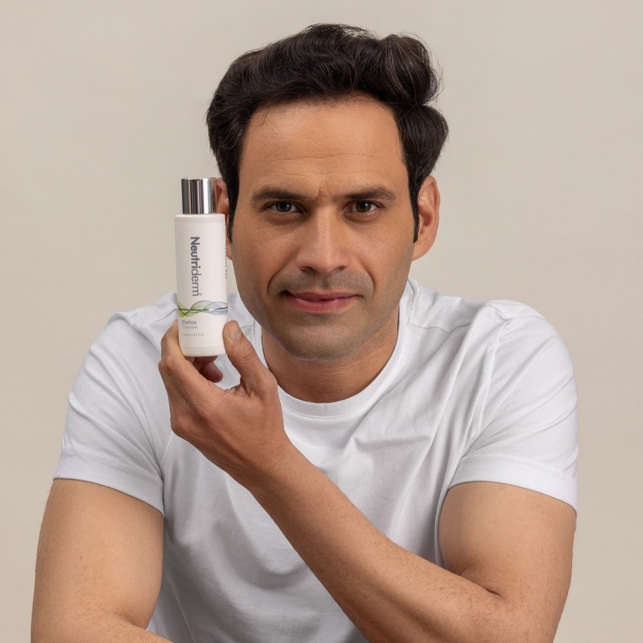 Man holding glycolic facial cleanser